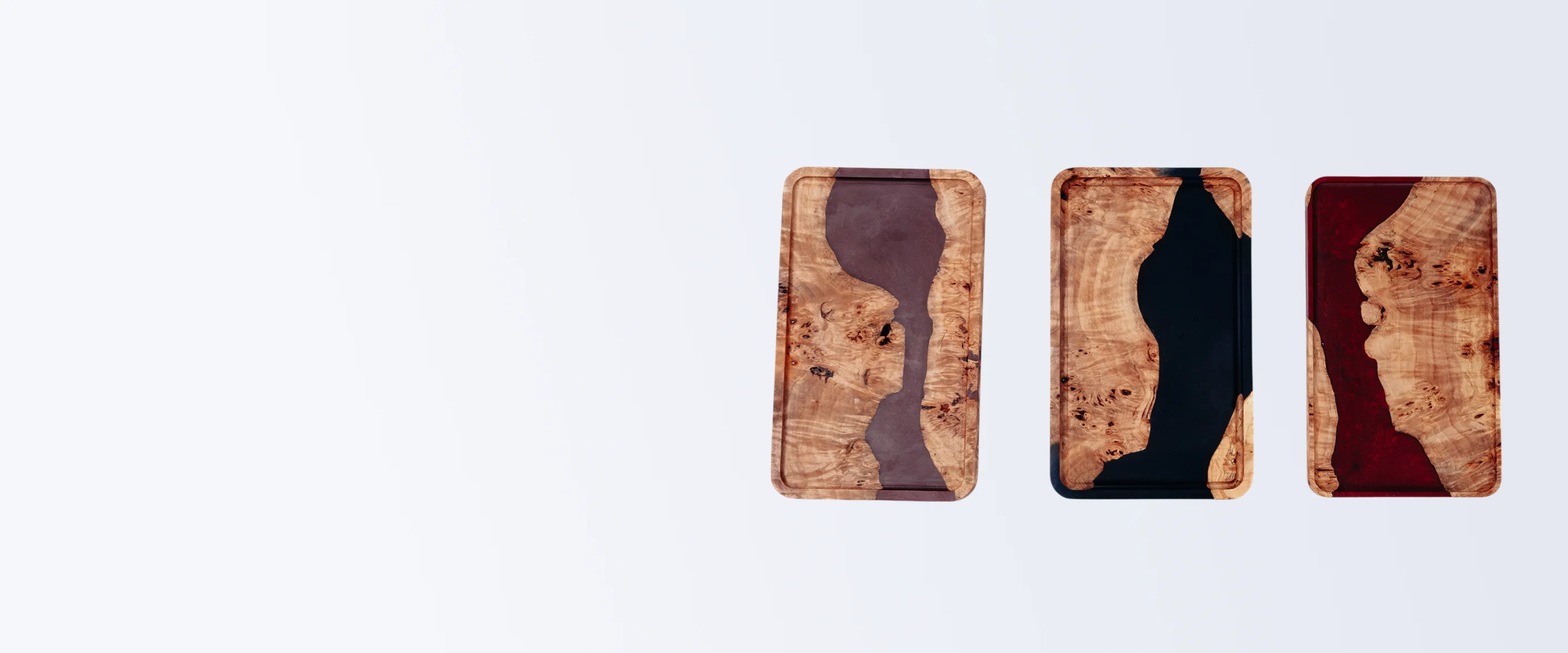 Three wooden coasters with resin designs on a white background